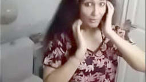 A stunning young woman flaunts her breasts in a seductive video