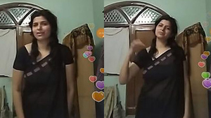 Indian auntie flaunts her curves in black transparent saree