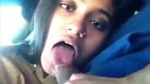 An Indian girlfriend performs oral sex on her boyfriend in a vehicle