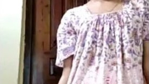 A stunning woman provocatively displays her breasts and intimate parts on film