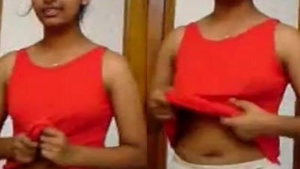 A young Indian woman reveals her breasts and belly button