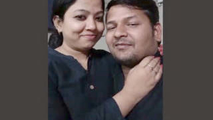 Attractive pair kissing in professional setting