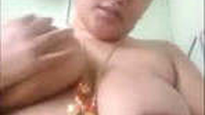 A curvy woman with large breasts receives adoration while wearing a tank top