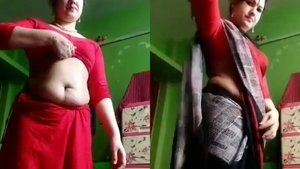 Indian bhabi in red saree strips and teases in front of camera