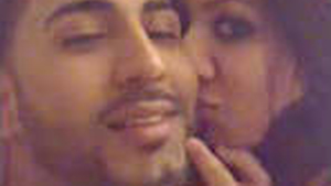 A stunning young woman and her partner engage in intimate bedroom activities