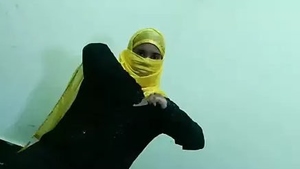 A woman wearing a hijab has intimate contact with a man from behind in this sensual video