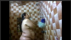 An Indian woman with large breasts gets passionate in the shower