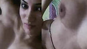 Beautiful chick playing with her perfect XXX breasts poses naked on camera