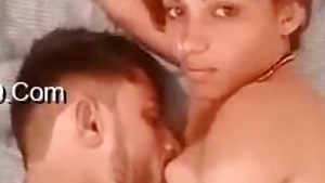 Indian couple lie next to each other and expose private body parts
